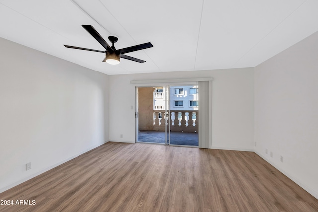 empty room with ceiling fan and hardwood / wood-style flooring