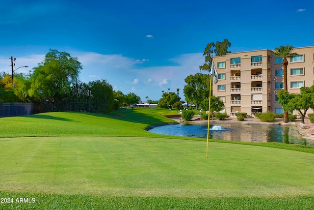 view of community featuring a yard and a water view