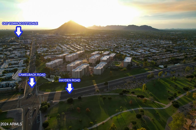 aerial view at dusk featuring a mountain view