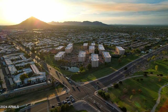 aerial view at dusk featuring a mountain view