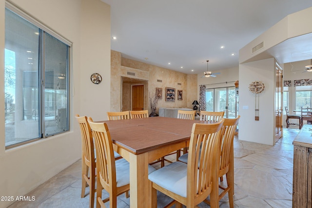 dining space with stone tile floors, visible vents, a ceiling fan, and recessed lighting