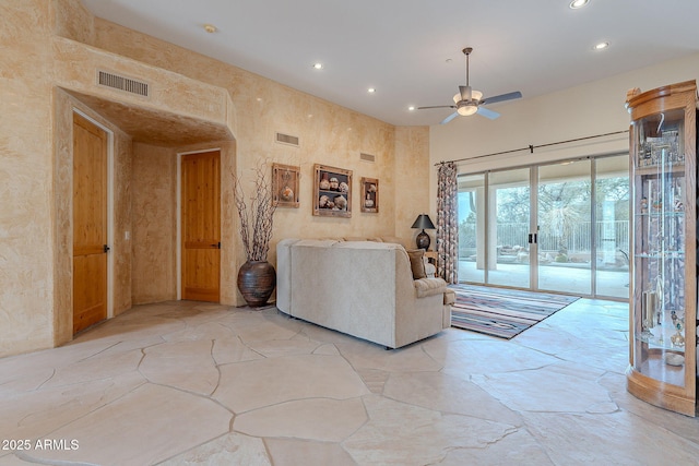 living area featuring a ceiling fan, visible vents, and recessed lighting