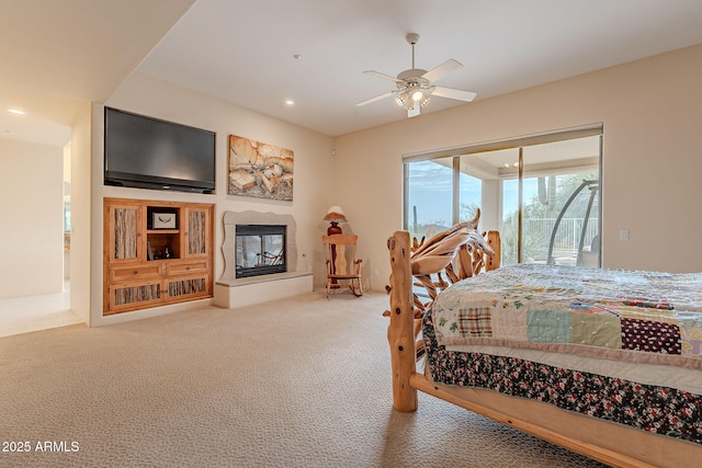 bedroom with a glass covered fireplace, ceiling fan, access to exterior, carpet floors, and recessed lighting