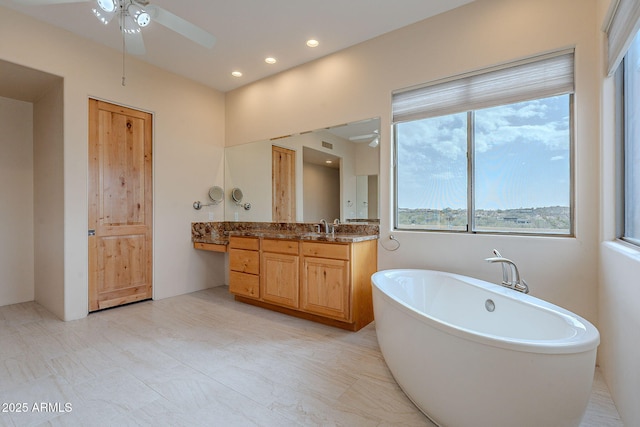 full bathroom with recessed lighting, a ceiling fan, a freestanding bath, and vanity