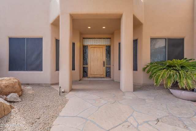 entrance to property with stucco siding