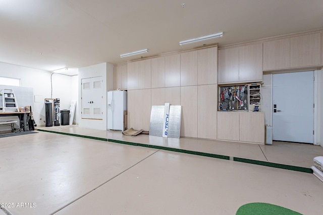 garage with white fridge with ice dispenser