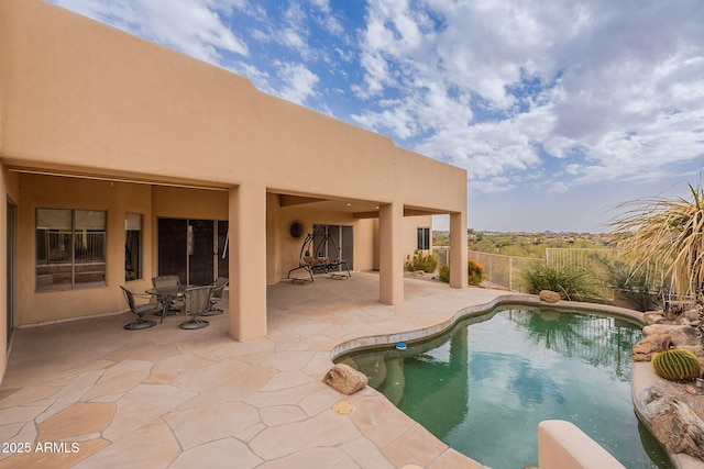 view of pool featuring fence, a fenced in pool, and a patio