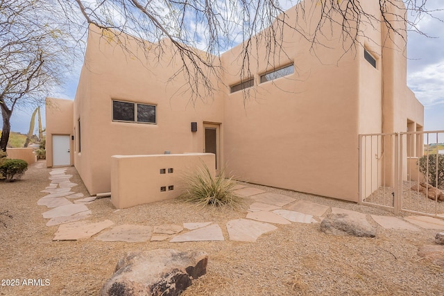 view of side of home featuring stucco siding