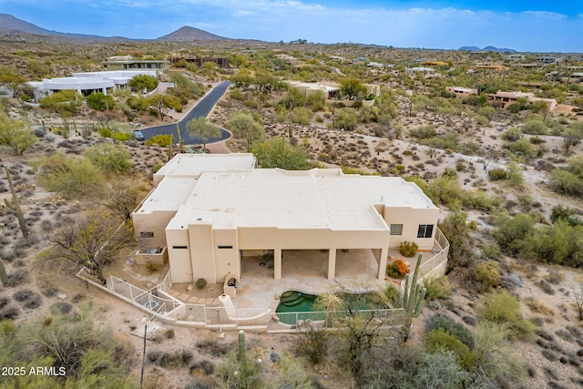 birds eye view of property with a mountain view and a desert view