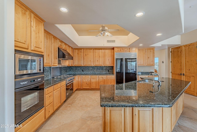 kitchen with visible vents, a raised ceiling, under cabinet range hood, black appliances, and a sink