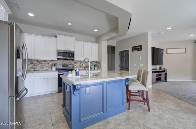 10402 E Javelina Ave, Mesa, AZ 85209 - kitchen with appliances with stainless steel finishes, a sink, backsplash, light stone countertops, and white cabinetry
