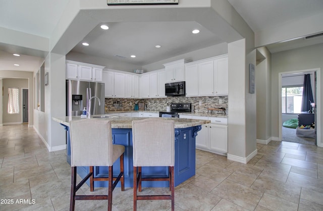10402 E Javelina Ave, Mesa, AZ 85209 - kitchen with black electric range, stainless steel refrigerator with ice dispenser, backsplash, a sink, and baseboards