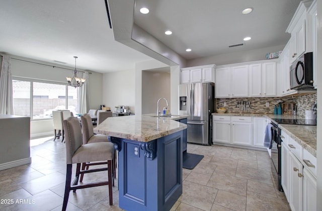 10402 E Javelina Ave, Mesa, AZ 85209 - kitchen with stainless steel refrigerator with ice dispenser, range with electric cooktop, a sink, a chandelier, and backsplash