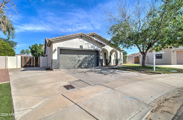 10402 E Javelina Ave, Mesa, AZ 85209 - view of front of home with driveway, an attached garage, a gate, stucco siding, and a tiled roof