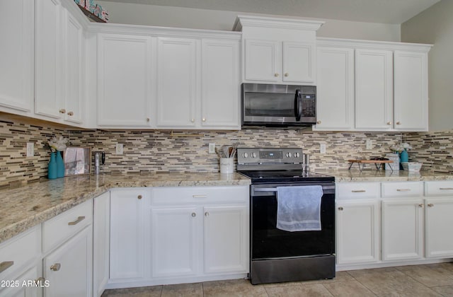 10402 E Javelina Ave, Mesa, AZ 85209 - kitchen with electric range oven, white cabinets, light stone countertops, and tasteful backsplash