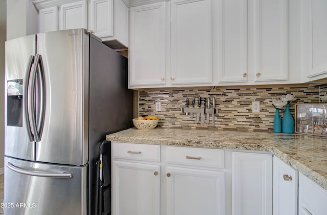 10402 E Javelina Ave, Mesa, AZ 85209 - kitchen with stainless steel fridge, decorative backsplash, white cabinetry, and light stone counters