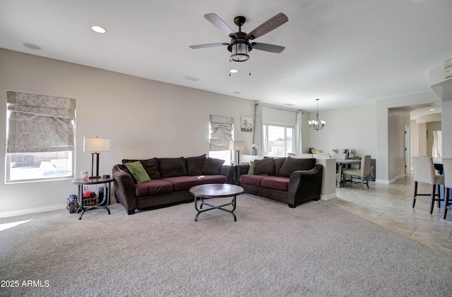 10402 E Javelina Ave, Mesa, AZ 85209 - living room featuring a chandelier, ceiling fan, light colored carpet, and baseboards