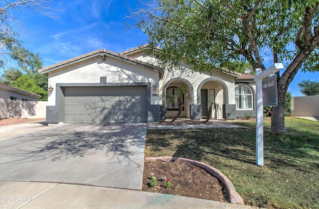 10402 E Javelina Ave, Mesa, AZ 85209 - view of front of home featuring an attached garage, concrete driveway, stucco siding, and a front yard