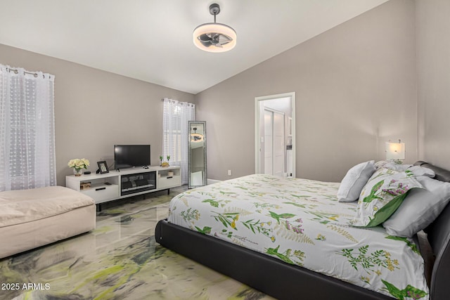 bedroom featuring lofted ceiling and marble finish floor