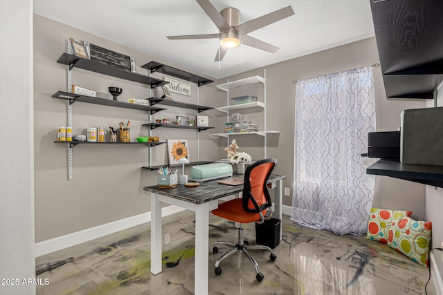 office space featuring a ceiling fan and baseboards