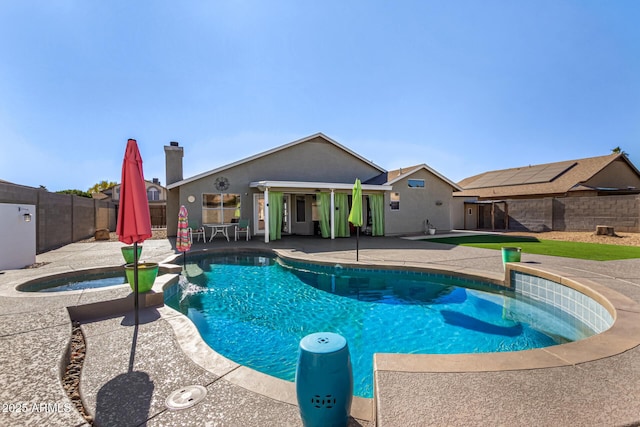 view of pool featuring a patio area, a fenced backyard, a fenced in pool, and an in ground hot tub