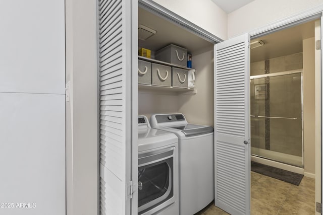 laundry area with light tile patterned floors, laundry area, and separate washer and dryer