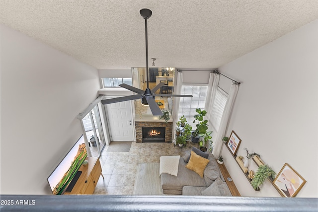 living room with plenty of natural light, a fireplace, and a textured ceiling