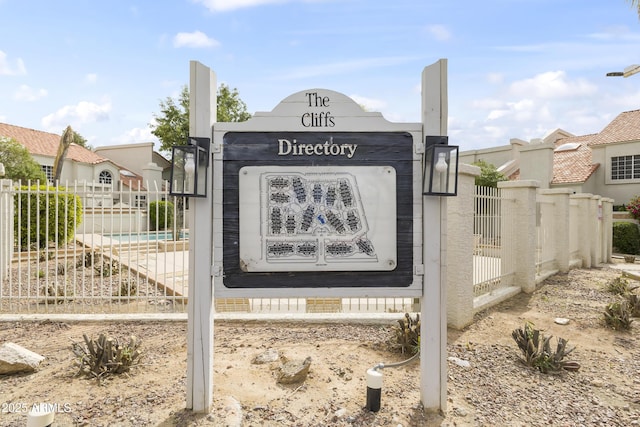 community sign featuring fence