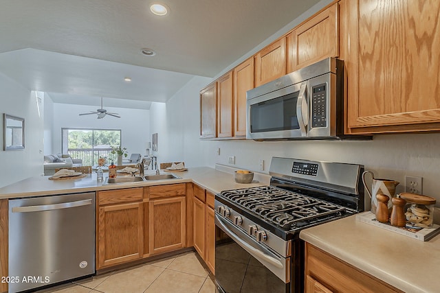 205 N 74th St Unit 261, Mesa, AZ 85207 - kitchen featuring stainless steel appliances, a peninsula, light tile patterned floors, light countertops, and recessed lighting