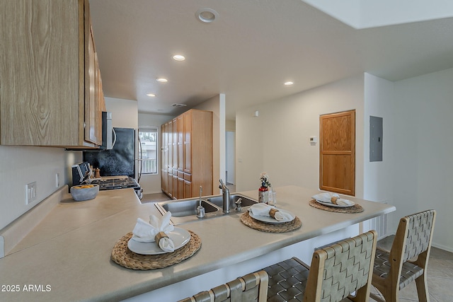 205 N 74th St Unit 261, Mesa, AZ 85207 - kitchen with gas stove, electric panel, a kitchen bar, light countertops, and recessed lighting