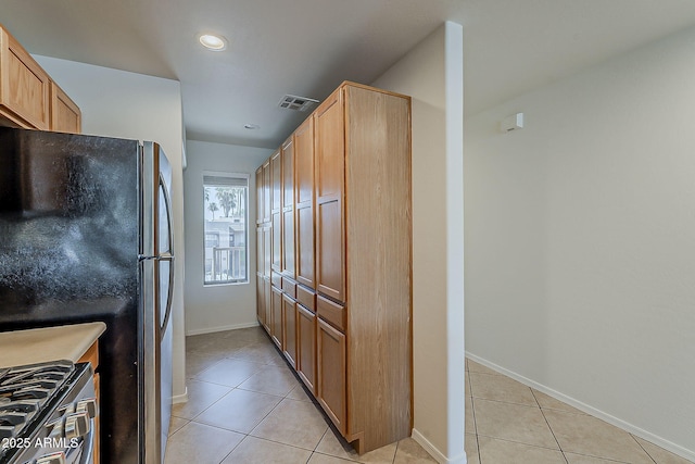205 N 74th St Unit 261, Mesa, AZ 85207 - kitchen featuring freestanding refrigerator, range with gas stovetop, light tile patterned floors, and recessed lighting