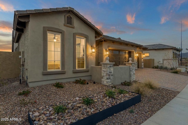 5756 E Star Valley St, Mesa, AZ 85215 - mediterranean / spanish house featuring a garage, decorative driveway, stucco siding, and fence