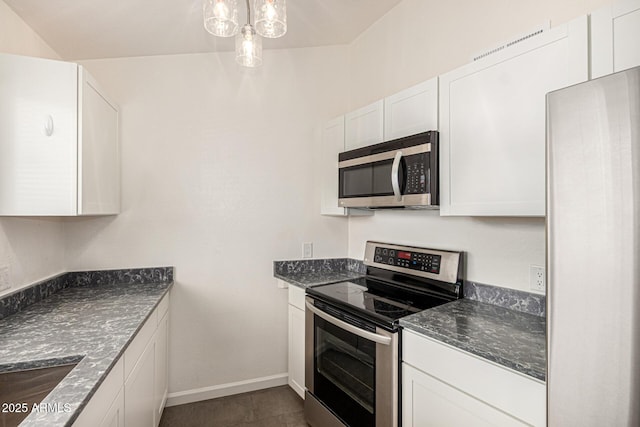 3039 W Ross Ave, Phoenix, AZ 85027 - kitchen featuring stainless steel appliances, white cabinets, baseboards, dark stone countertops, and a chandelier