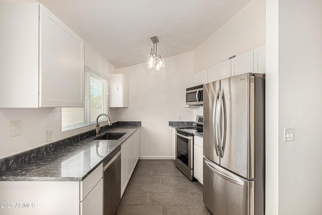 3039 W Ross Ave, Phoenix, AZ 85027 - kitchen featuring stainless steel appliances, a sink, white cabinetry, dark stone counters, and a chandelier