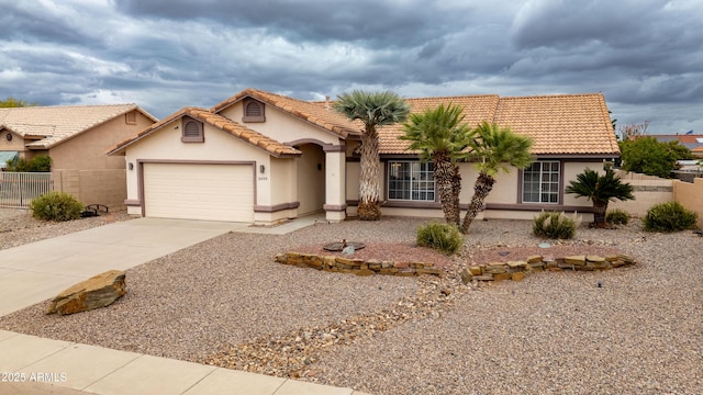 view of front of house with fence, a garage, concrete driveway, stucco siding, and a tile roof