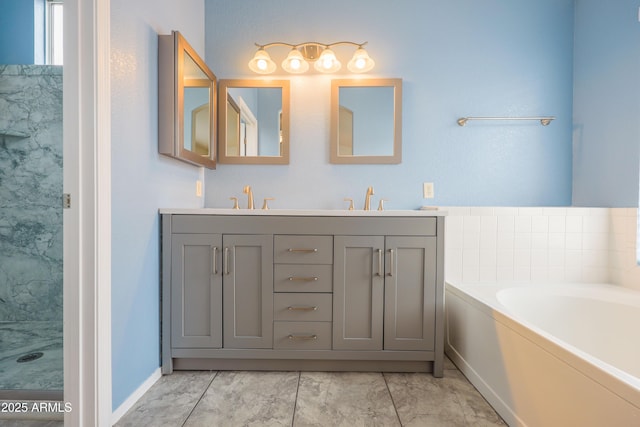bathroom featuring a bath, double vanity, and marble look tiles