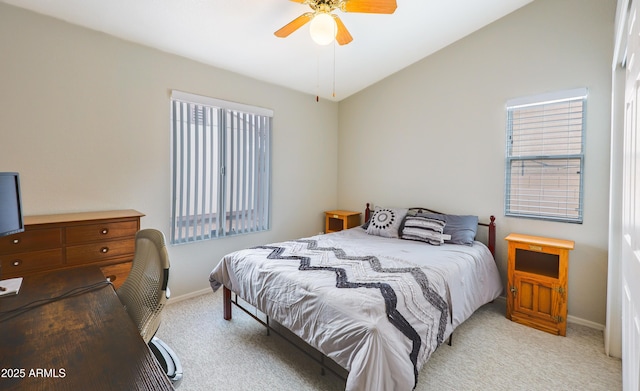bedroom featuring carpet flooring, baseboards, multiple windows, vaulted ceiling, and ceiling fan