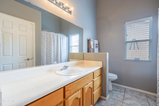 full bathroom with vanity, toilet, baseboards, and tile patterned floors