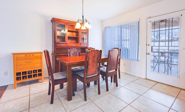 dining area featuring a chandelier and light tile patterned flooring
