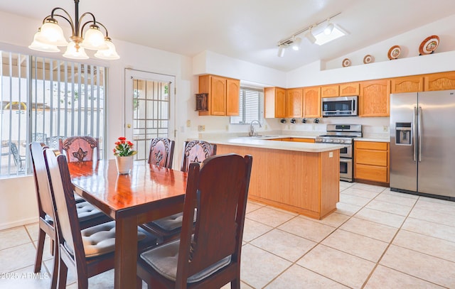 kitchen with stainless steel appliances, light tile patterned floors, light countertops, vaulted ceiling, and a chandelier