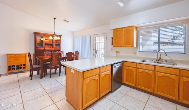 kitchen featuring stainless steel dishwasher, a sink, a peninsula, and light countertops