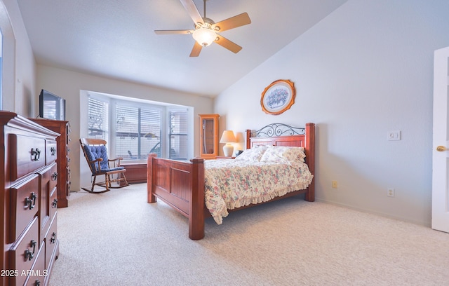 carpeted bedroom with lofted ceiling and a ceiling fan