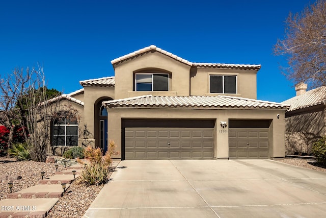 mediterranean / spanish-style house featuring a garage, concrete driveway, a tiled roof, and stucco siding