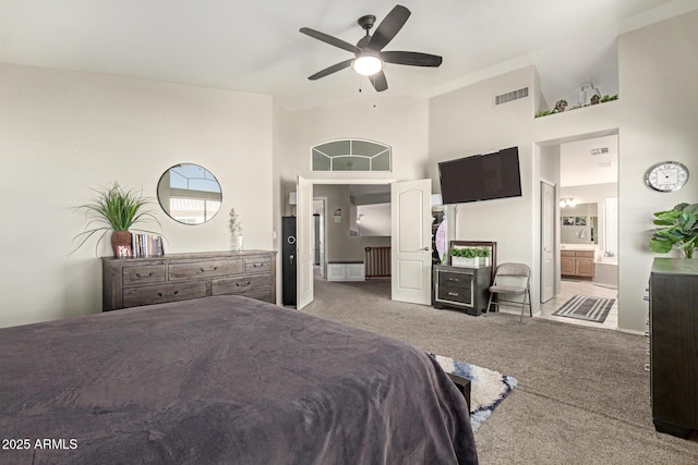 bedroom with carpet, visible vents, ceiling fan, and ensuite bathroom