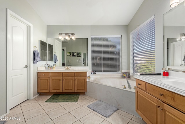 bathroom featuring two vanities, a sink, a bath, and tile patterned floors