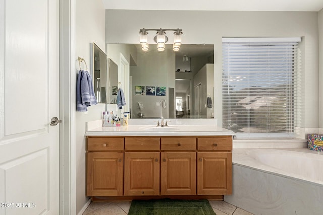 full bath with a bath, vanity, and tile patterned floors