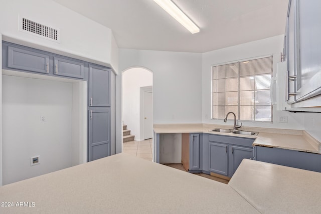 kitchen with light tile patterned floors and sink