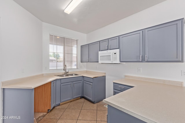 kitchen featuring sink and light tile patterned floors