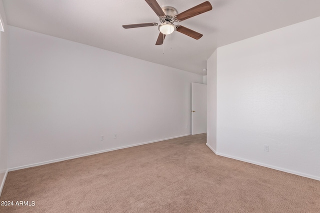 unfurnished room featuring light carpet and ceiling fan