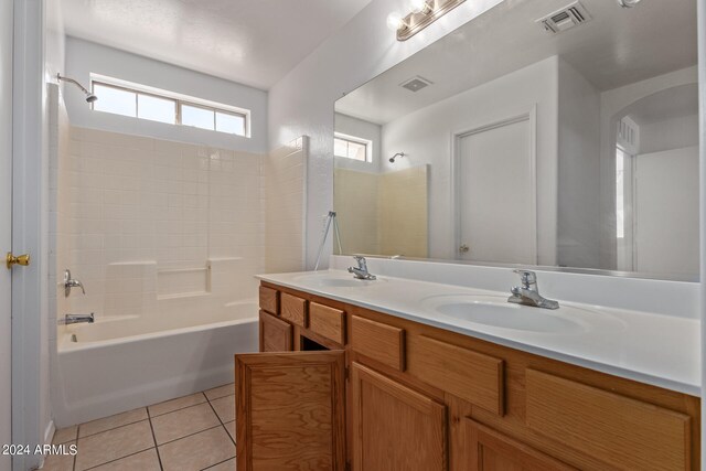 bathroom with tub / shower combination, tile patterned flooring, and vanity